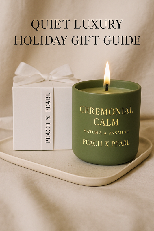 Quiet-luxury holiday flatlay with cream ribbon, Matcha & Jasmine candle, and recipe card — elegant holiday gifts under $50 for the woman who has everything.